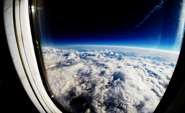 The earth's cloudy sky as seen through a window just above the atmosphere