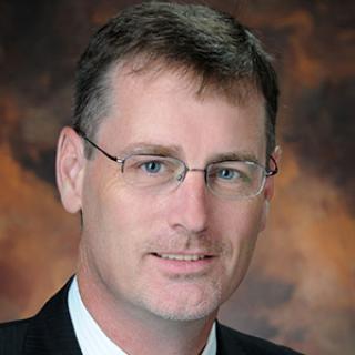 A professional headshot of Dr. John Horack