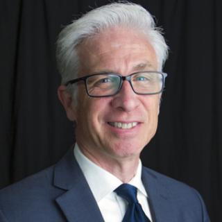 A professional headshot of David Staley