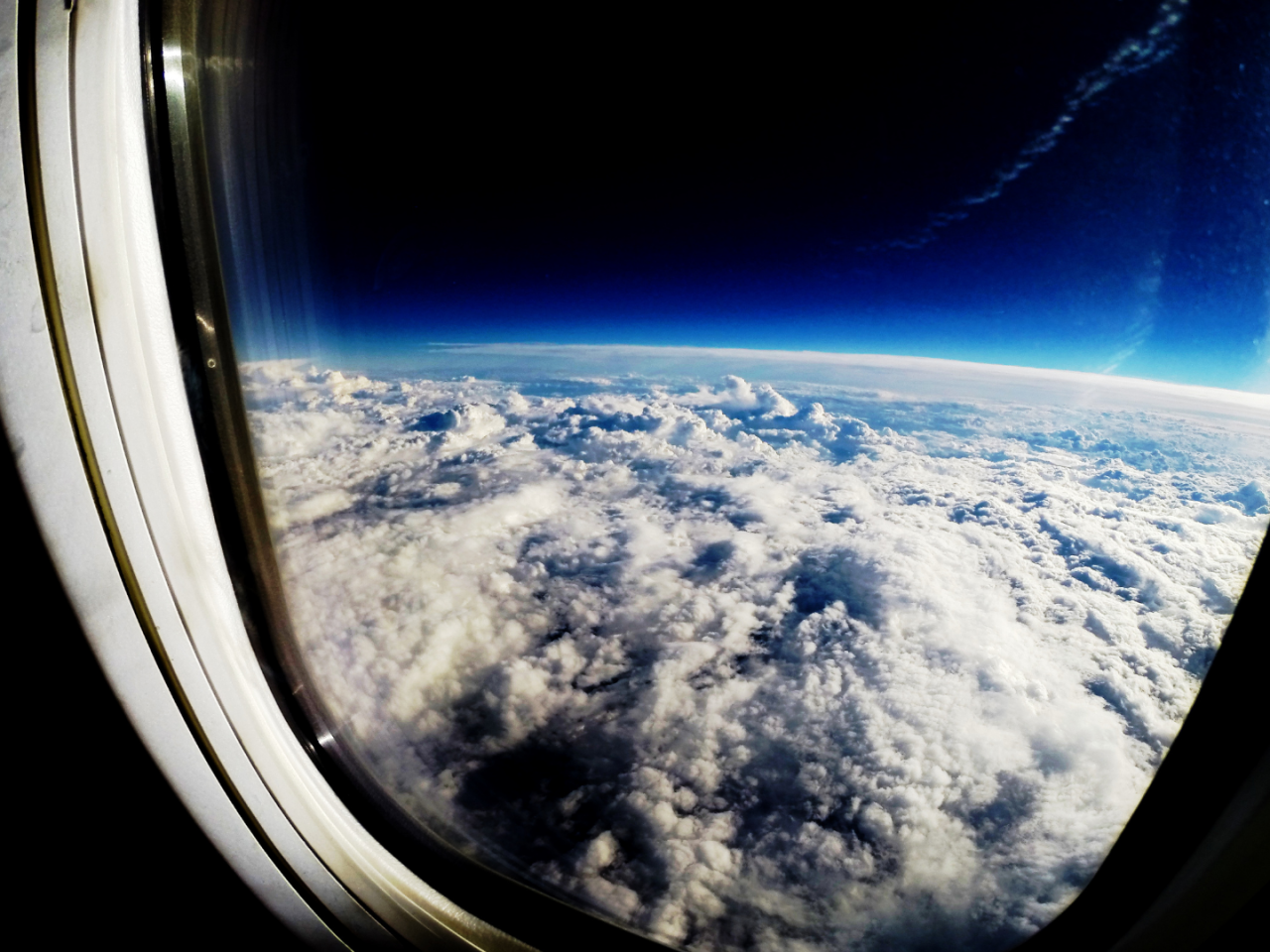 The earth's cloudy sky as seen through a window just above the atmosphere