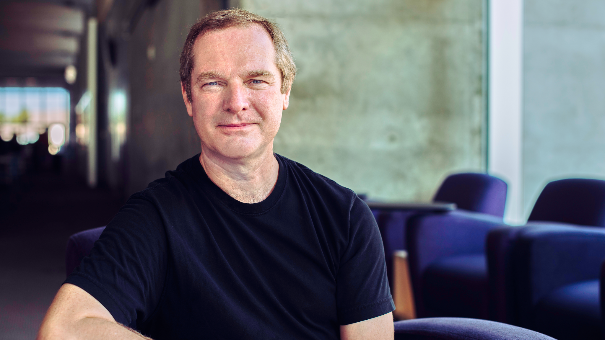A shot of professor Andrew Maynard seated in an arm chair