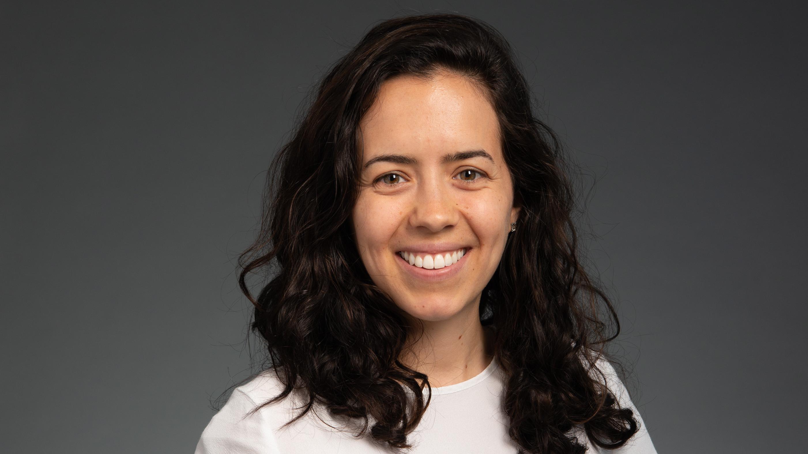 Headshot for Ali Stano against a black and white background