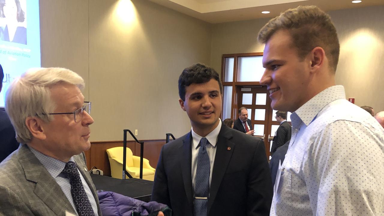 Two students speak with the president of the American Institute of Aeronautics and Astronautics and a student run conference