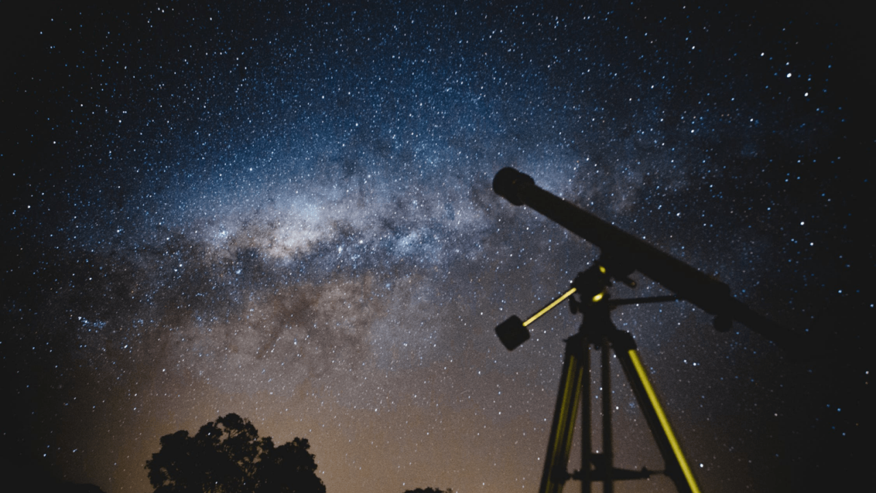 A telescope aimed up at the milky way in the sky