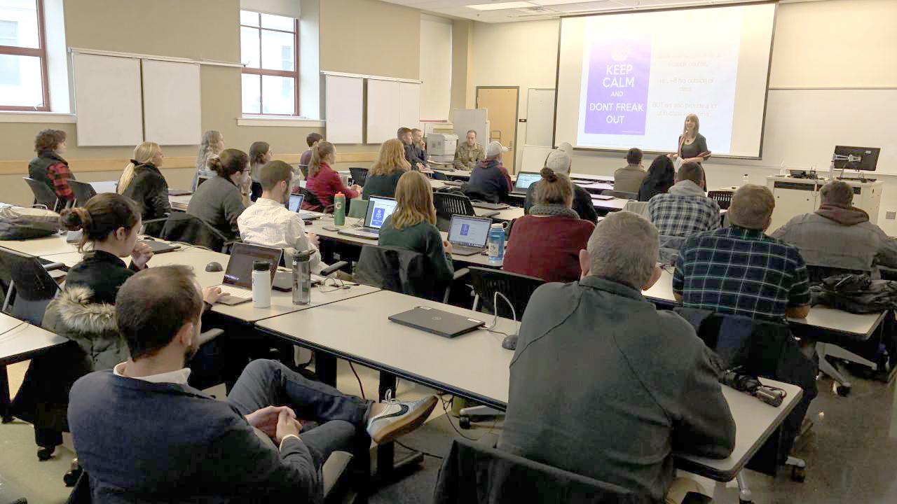 Class of students looking at projector screen